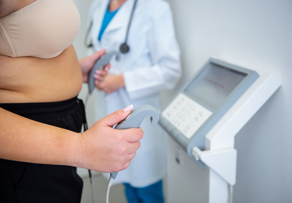 a clinician stands in the background watching an overweight patient use the InBody scan to create a baseline for medical weight loss in Murrysville, PA, treatments.